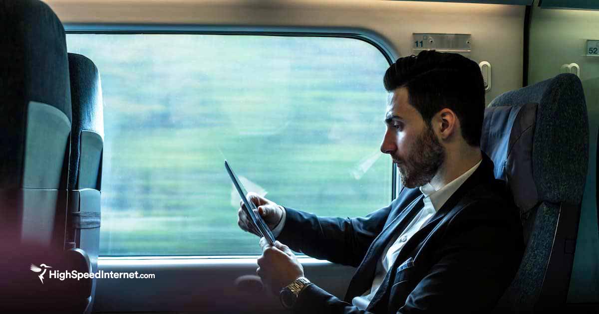 man using tablet on train